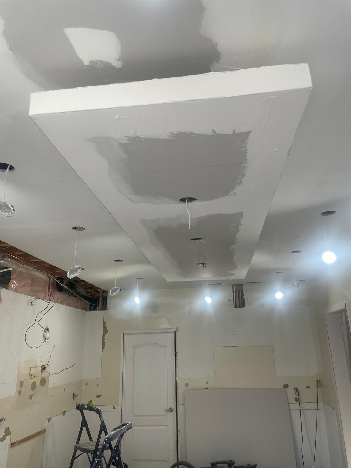 Ceiling bulkhead in drywall with pot lights wired in during a Brampton renovation