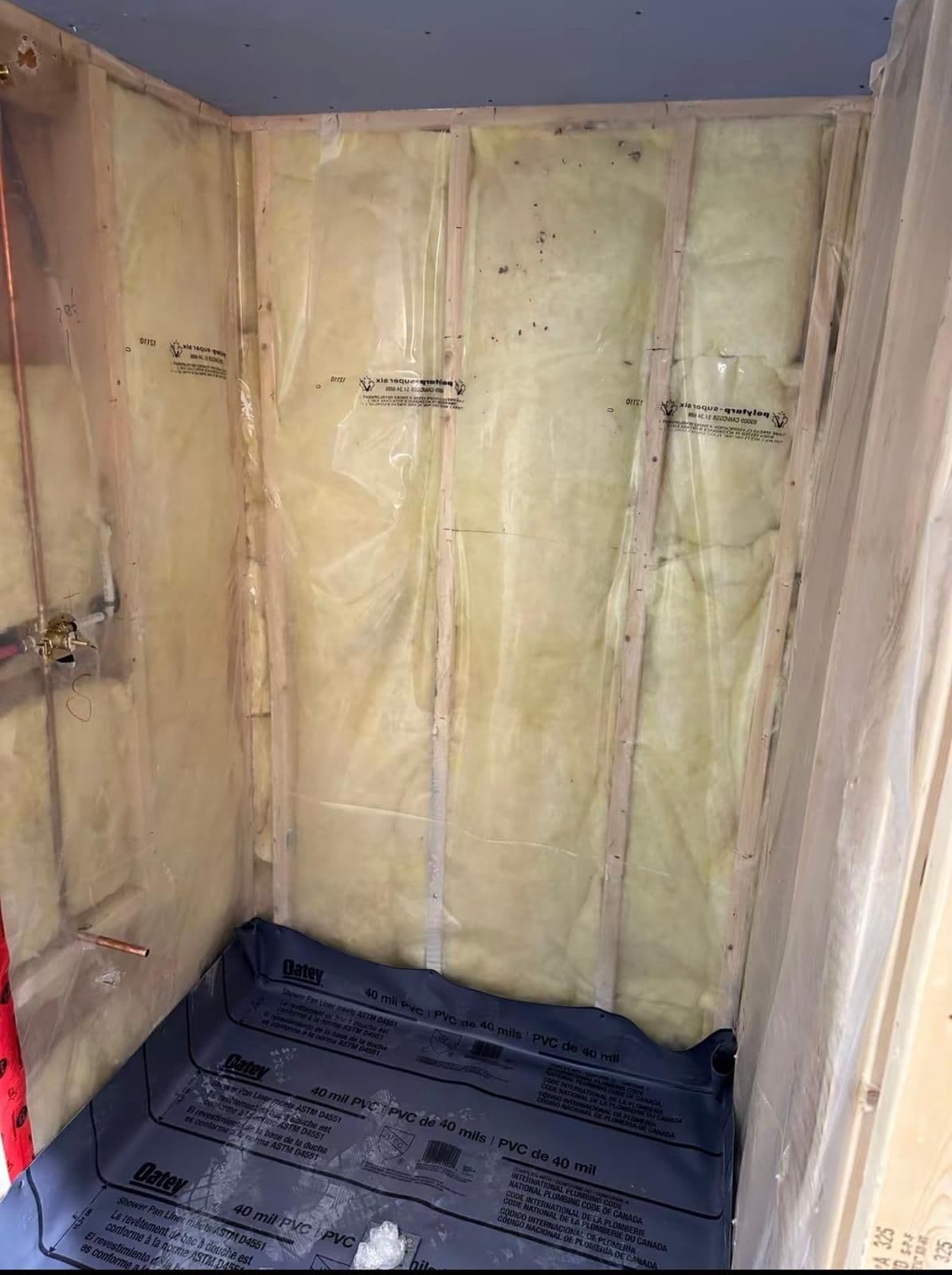 Shower framed down to the studs with insulation and a waterproof pan liner, Brampton